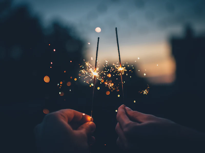 Sparklers held at dusk