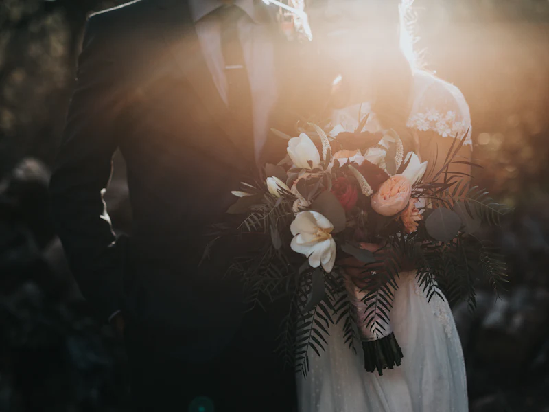 A couple in wedding attire holding a bouquet